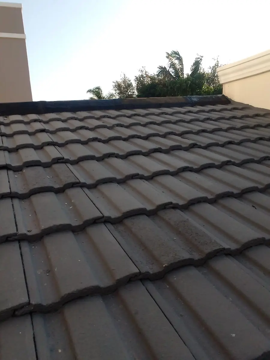 Concrete tile roof with waterproofed ridge capping