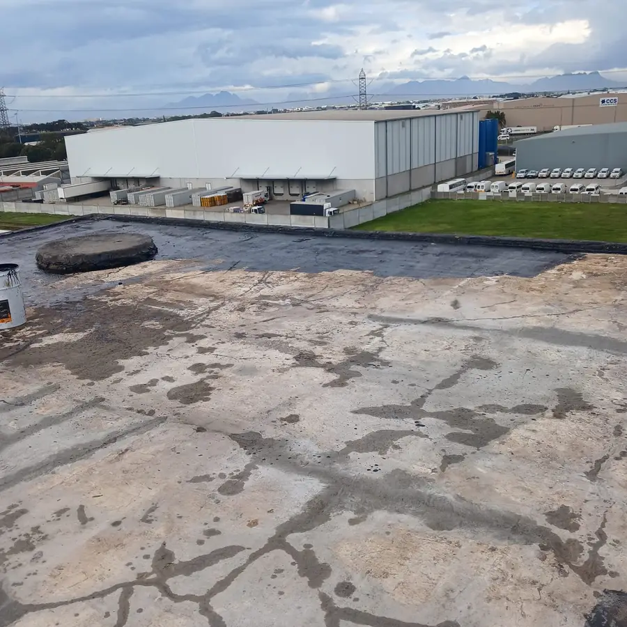 Large industrial flat roof being prepared for waterproofing in Cape Town